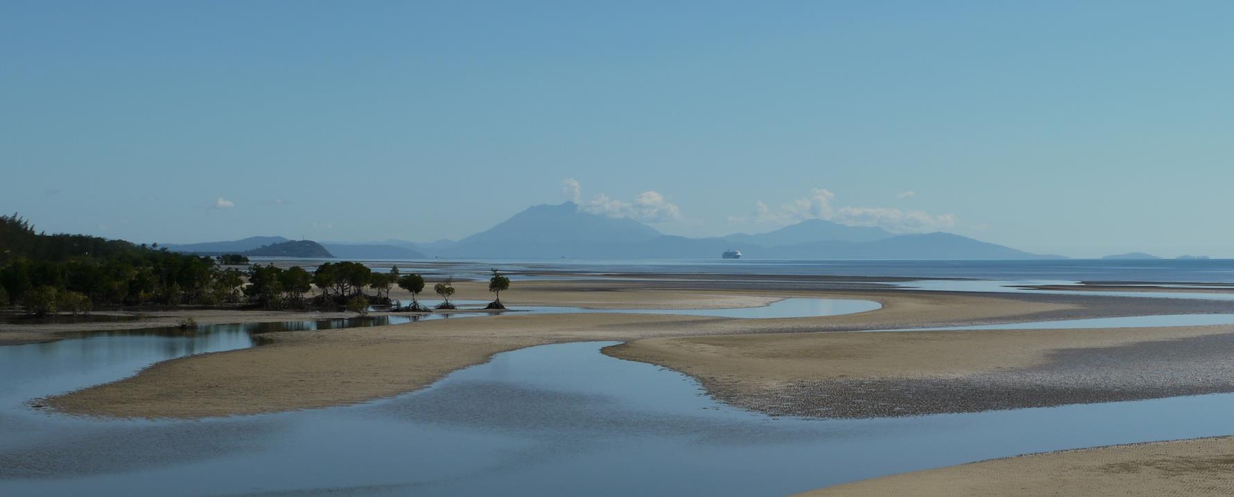 Low tide at Yule Point and a cruise ship off Port Douglas